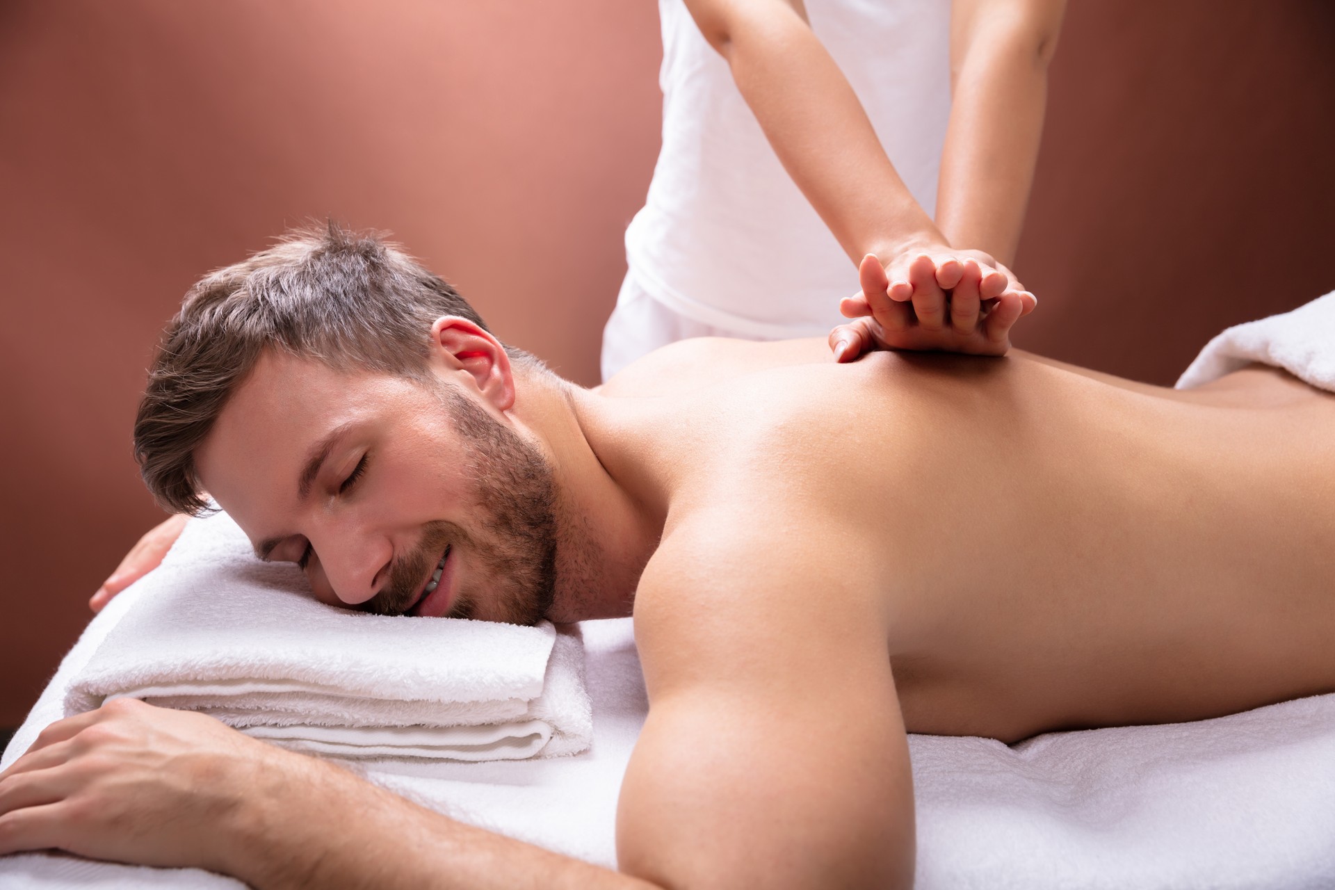 Therapist Giving Back Massage To Man